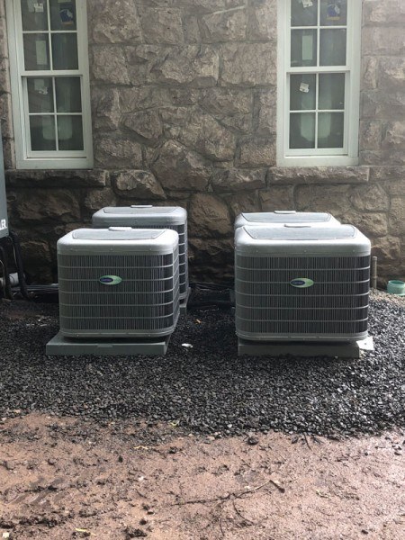 Four Carrier Air Conditioners Outside a Home