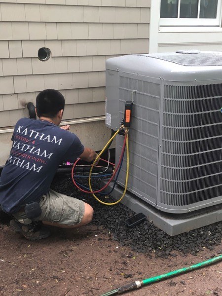 A Katham Industries Service Technician Works on a Carrier Air Conditioner
