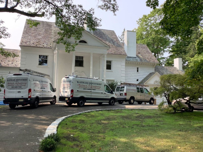 Three Katham Industries Service Vehicles at a job site